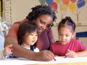 Teacher and children drawing